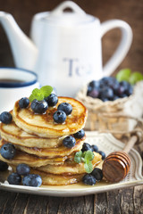 Stack of pancakes with fresh blueberry and honey