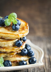 Stack of pancakes with fresh blueberry and honey