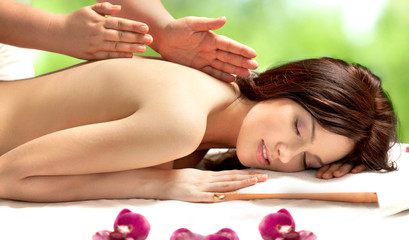 Fototapeta na wymiar Young Woman Having Massage in Spa Salon