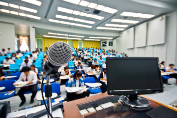 A microphone with blur background of many students learning