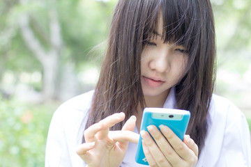 thai student teen beautiful girl using her smart phone