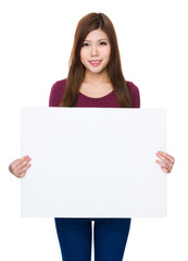 Fototapeta premium Young woman show with white poster
