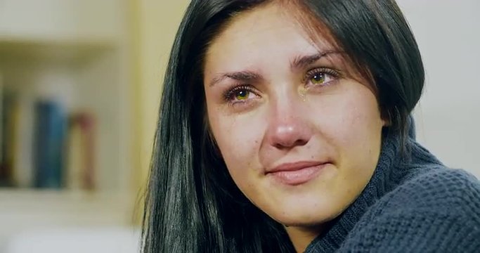 Young woman singing and crying at home closeup