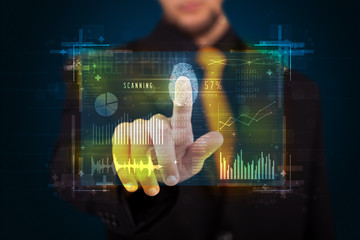 Young businessman pressing modern technology panel with finger p
