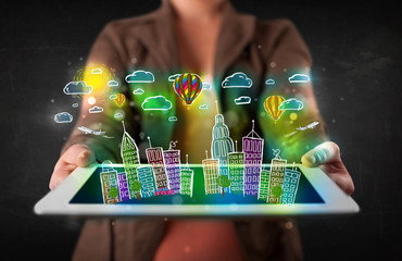 Young person showing tablet with hand drawn cityscape