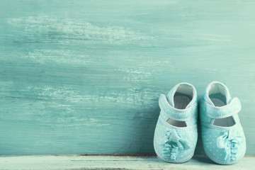 Colorful toddler shoes on wooden background