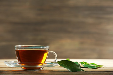 Cup of green tea on table on wooden background