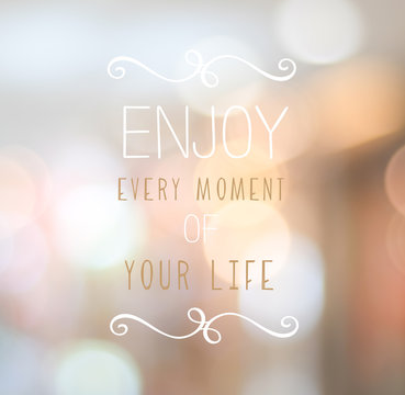 Enjoy every moment of your life text over blur abtract backgound