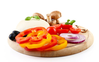 Food ingredients for pizza on cutting board isolated on white
