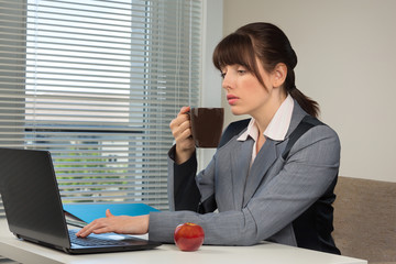 The image of business woman at coffee break in the office