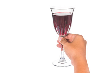Hand holding red wine in crystal glass ready to toast