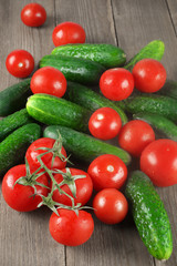 Tomatoes and cucumbers on wood