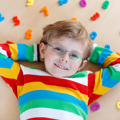 Kid boy with colorful numbers, indoor