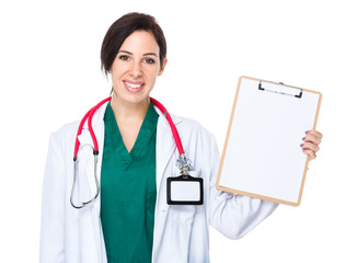 Woman doctor show with blank page of clipboard