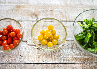 Ingredients for colorful vegetable salad laid on wooden table