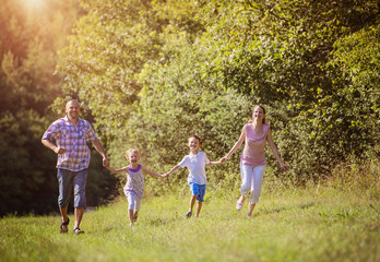 Obraz premium Happy family spending time together outside in green nature
