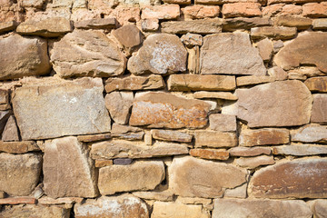Rustic wall with layers of different shapes of rough sandstones
