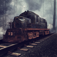 Fototapeta na wymiar Zardzewiała lokomotywa na torach w mglistym lesie