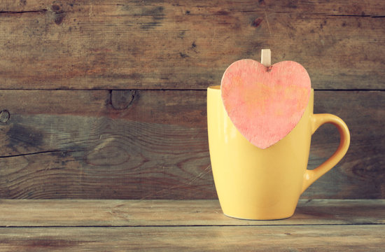 yellow mag with a wooden vintage pink heart 
