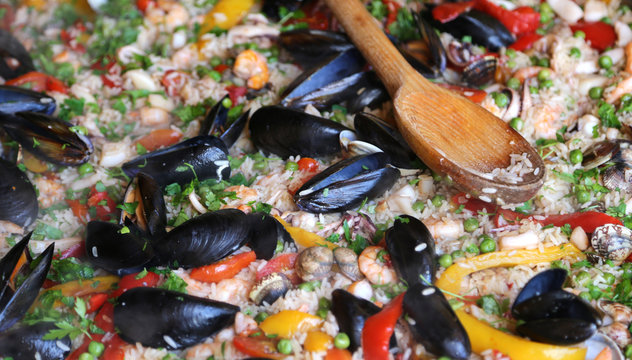 Valencian Paella rice with clams and mussels and green peas
