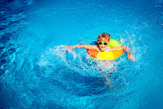 Happy Child Playing In Swimming Pool