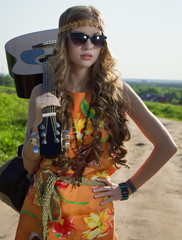 Romantic girl travelling with her guitar