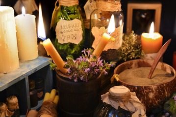 Close up of two candles with magic objects