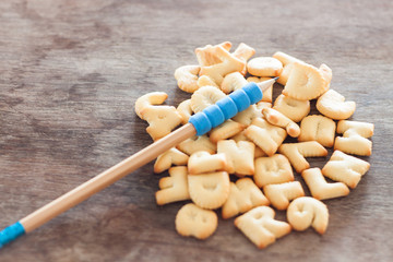 Alphabet biscuit on wooden table