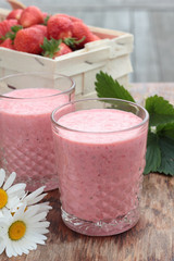 Two glasses of freshly prepared, delicious strawberry milkshake.
