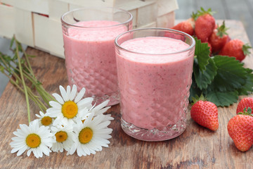 Two glasses of freshly prepared, delicious strawberry milkshake.