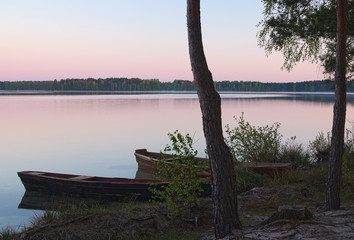 Sunrise on the lake and two boats on the shore (Pisochne ozero,