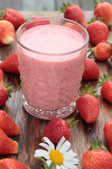 Two glasses of freshly prepared, delicious strawberry milkshake.