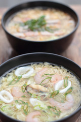 Bowl of oriental noodle and seafood soup.
