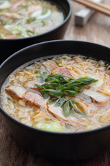 Bowl of oriental noodle and pork soup.