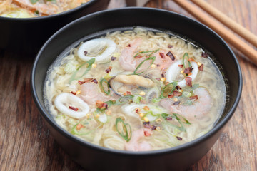 Bowl of oriental noodle and seafood soup.