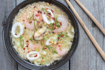 Bowl of oriental noodle and seafood soup.