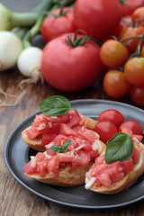 Three pieces of bruschetta on a tin plate.