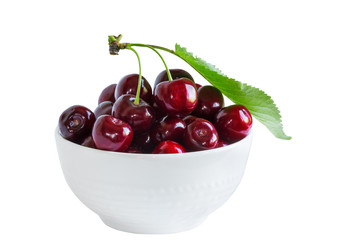 Cherry berries in a cup on a white background