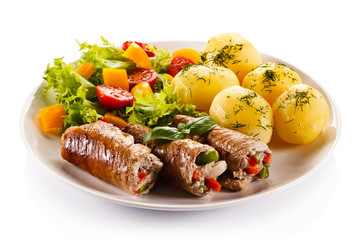 Wrapped pork chop, boiled potatoes and vegetables 