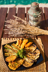 Serving of grilled zucchini, chicken and eggplant blue