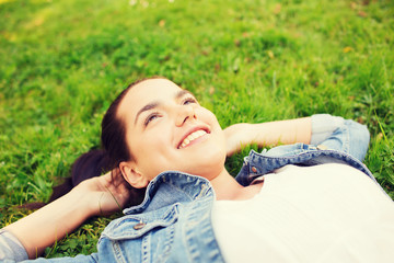 smiling young girl lying on grass