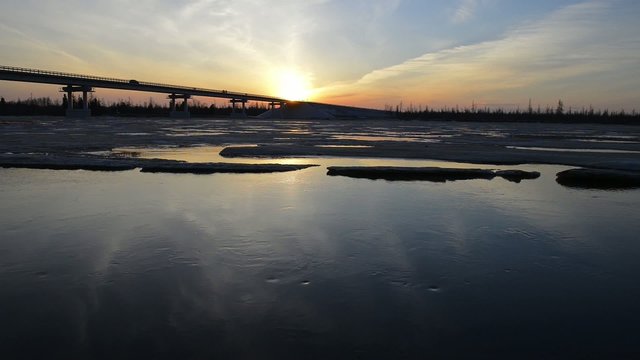 bridge over the river at sunset in Siberia