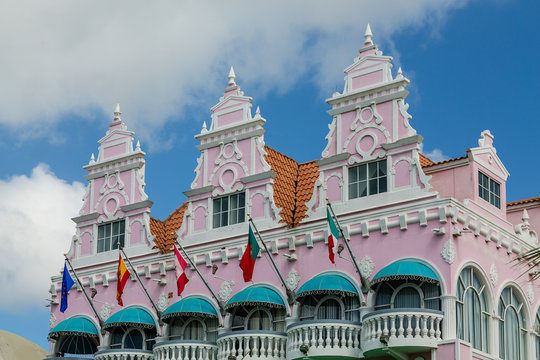 Flags and Green Awnings on Pink Stucco
