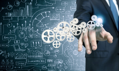 Businessman activating gears mechanism