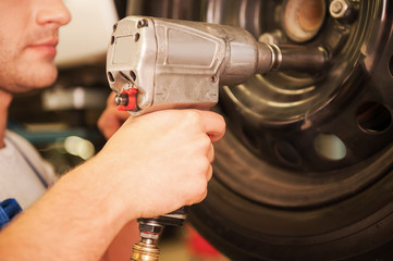 Removing tires from car. 