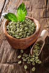 green coffee beans in wooden bowl