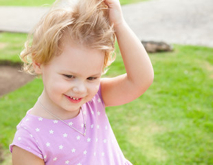 Outdoor summer portrait of cute playful girl