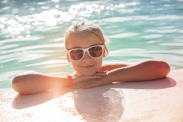 Beautiful little blond girl with sunglasses