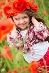 Little girl on poppy field