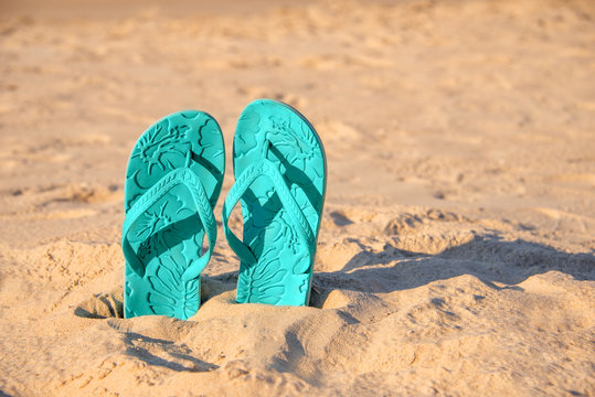 Flip Flops Stuck In The Sand Of A Beach